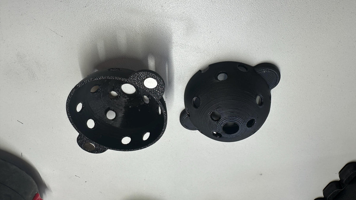Two halves of the Square Golf ball marker showing guide holes