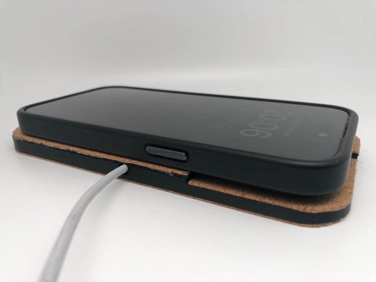Smartphone resting on the cork-finished wireless charging pad