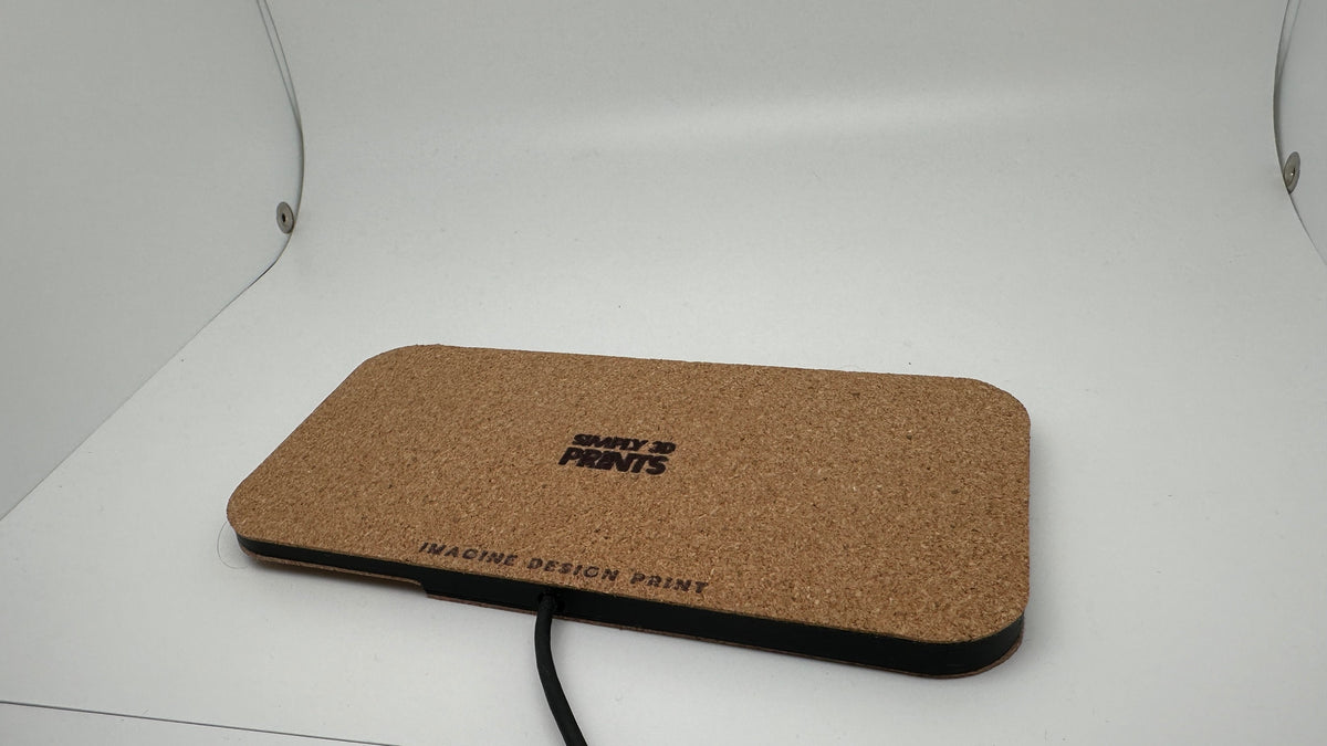 Reverse side of the cork-finished charging pad with Simply 3D Prints logo